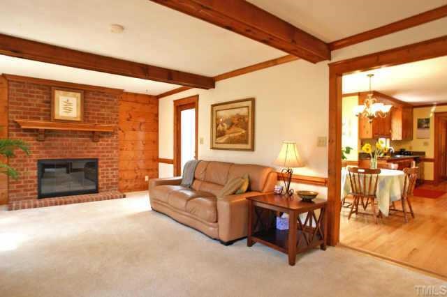 2832 Mattlyn Court Raleigh, NC 27613 - Photo 5 of 12 a living room with furniture a fireplace and a flat screen tv