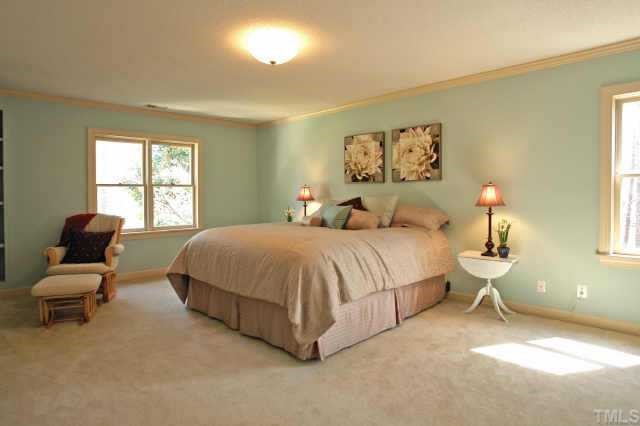 2832 Mattlyn Court Raleigh, NC 27613 - Photo 10 of 12 a spacious bedroom with a bed and a large window