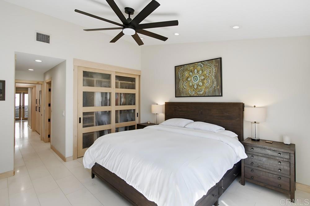 4590 Salem Place Carlsbad, CA 92010 - Photo 12 of 26 a bedroom with a large bed and a chandelier