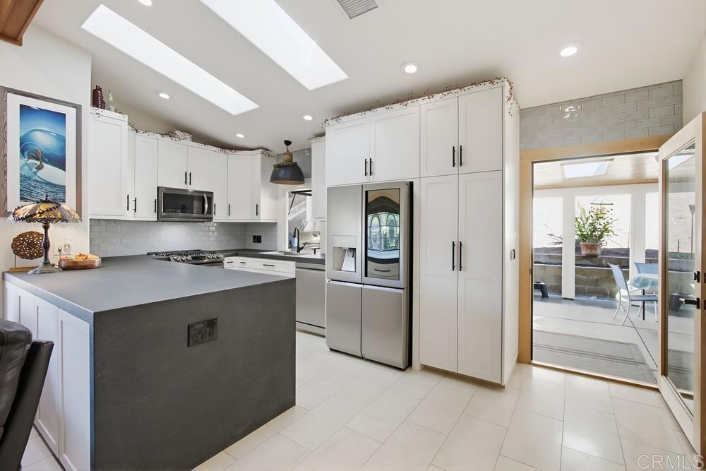 4590 Salem Place Carlsbad, CA 92010 - Photo 9 of 26 a kitchen with stainless steel appliances granite countertop a refrigerator a sink dishwasher a stove and a refrigerator