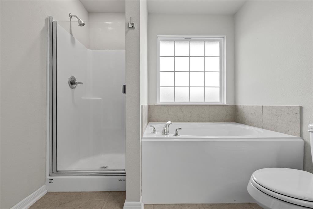 4056 Centerfire Road Waco, TX 76705 - Photo 16 of 27 a bathroom with a sink a toilet and shower