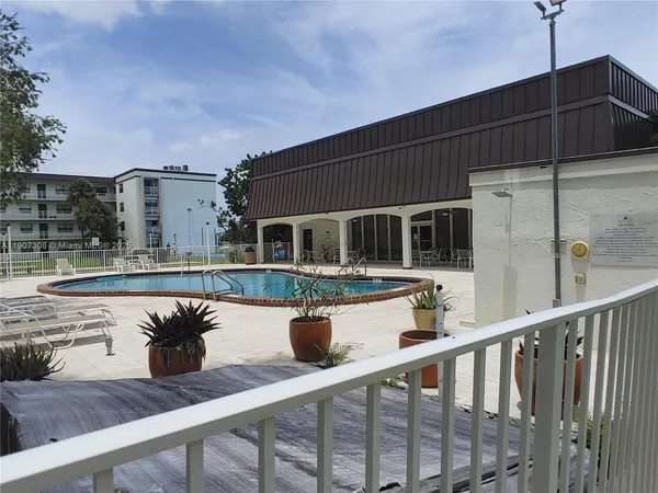 a view of balcony with two chairs and wooden floor