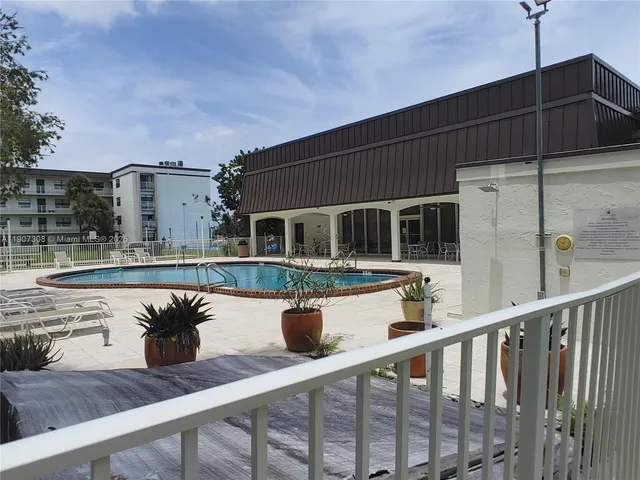a view of balcony with two chairs and wooden floor