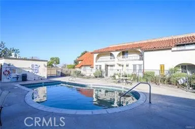 a view of a dining room with furniture a chandelier and wooden floor