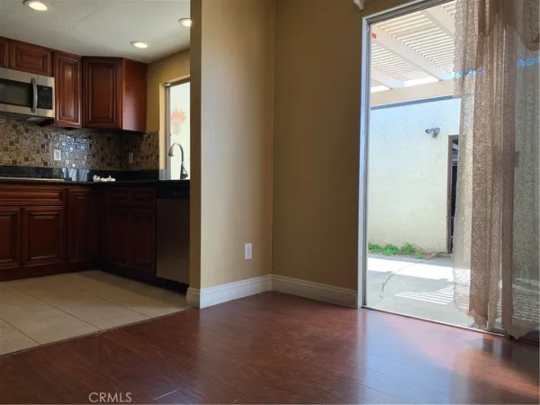 a view of kitchen with wooden floor and electronic appliances