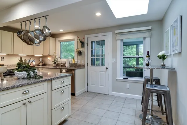 a kitchen with cabinets and window
