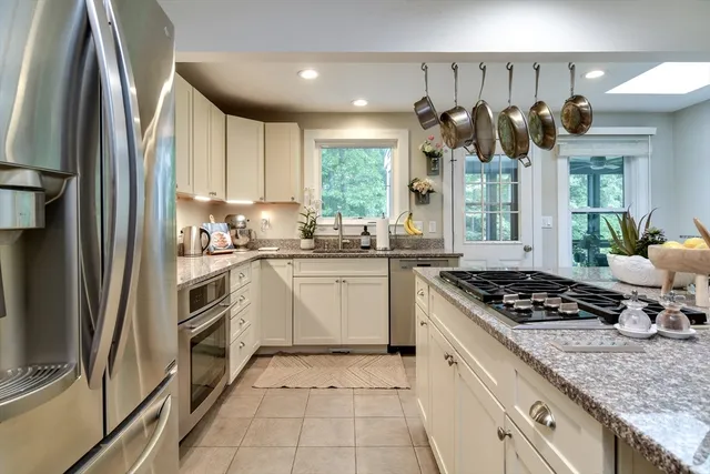 a kitchen with a sink window and cabinets