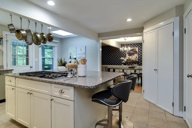 a kitchen with granite countertop a sink and cabinets