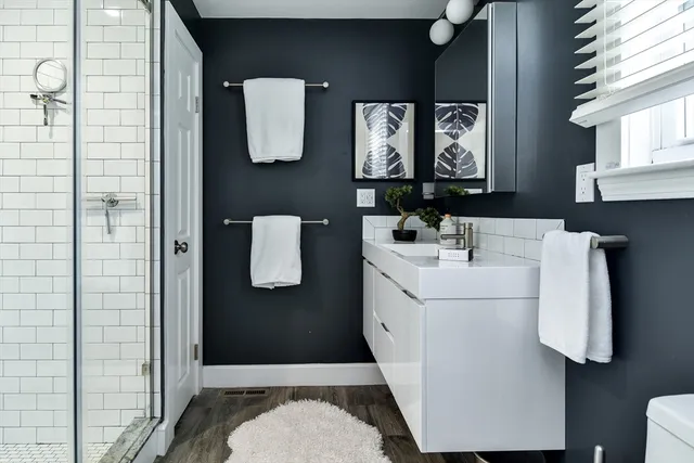 a bathroom with a sink toilet and mirror