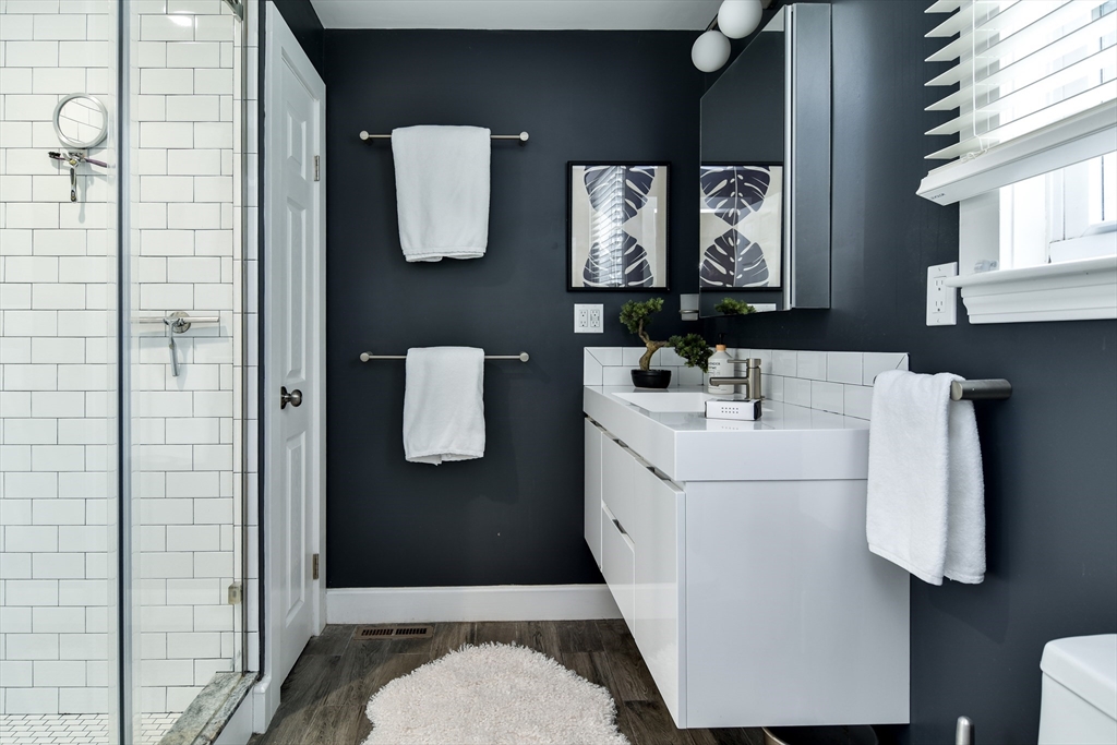 76 Pleasant Street South Natick, MA 01760 - Photo 18 of 36 a bathroom with a sink toilet and mirror