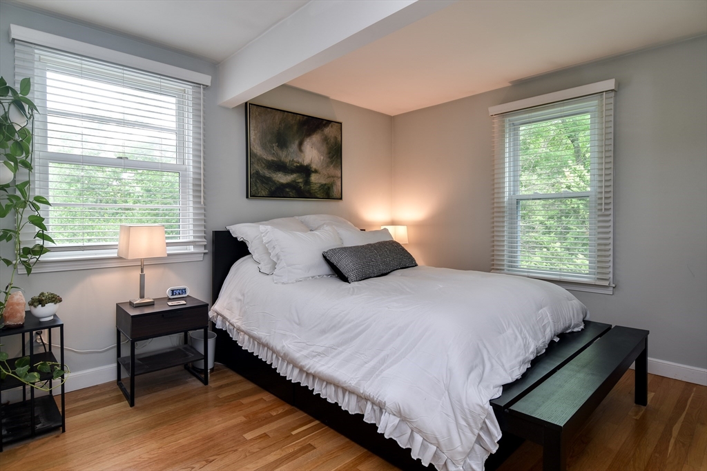 76 Pleasant Street South Natick, MA 01760 - Photo 19 of 36 a bedroom with a bed and wooden floor