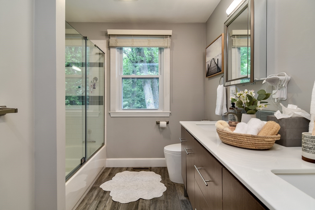 76 Pleasant Street South Natick, MA 01760 - Photo 20 of 36 a bathroom with a granite countertop sink and a mirror