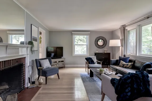 a living room with furniture a fireplace and a flat screen tv