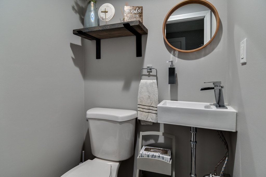 76 Pleasant Street South Natick, MA 01760 - Photo 23 of 36 a bathroom with a toilet a sink and a mirror