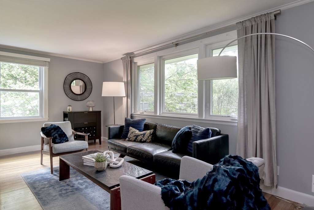 76 Pleasant Street South Natick, MA 01760 - Photo 3 of 36 a living room with furniture and a fireplace