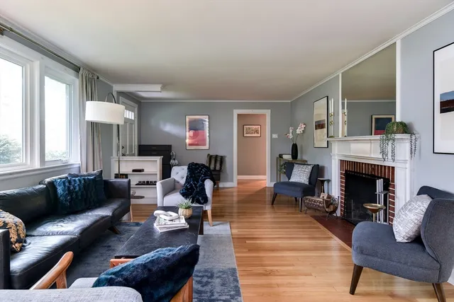 a living room with furniture fireplace and window