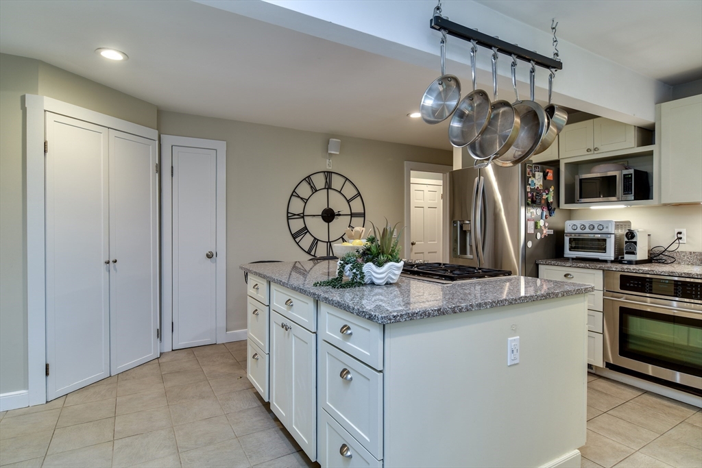 76 Pleasant Street South Natick, MA 01760 - Photo 9 of 36 a kitchen with stainless steel appliances granite countertop a sink and cabinets