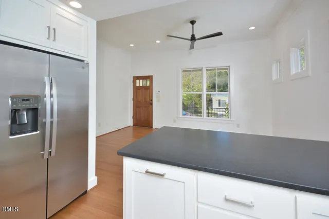 a kitchen with a refrigerator and a window