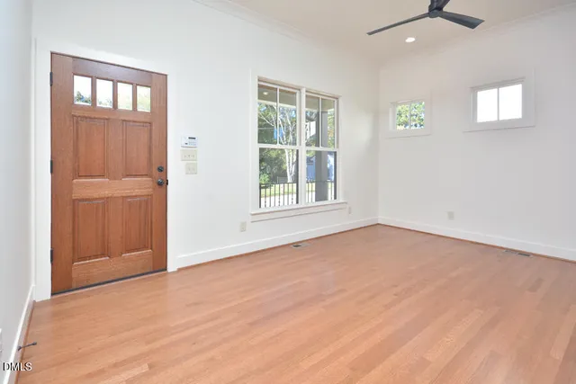 an empty room with windows and closet