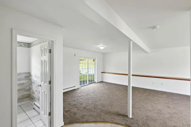 a view of a big room with windows and entryway