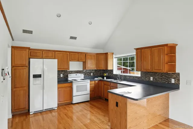 a kitchen with a sink stove and refrigerator
