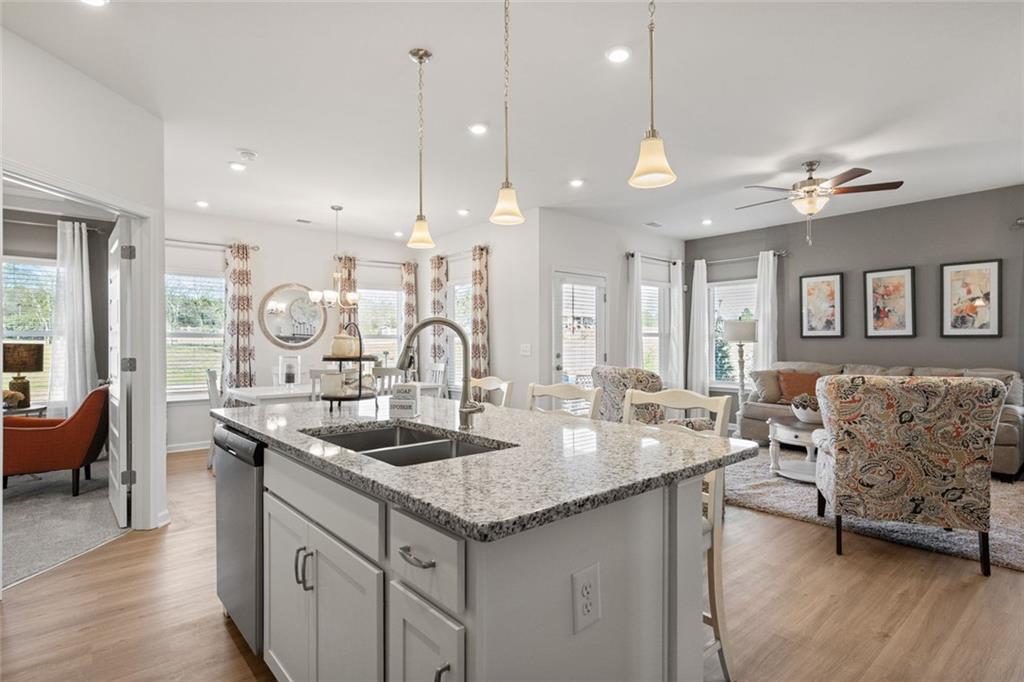 23 Willow Circle Rock Spring, GA 30739 - Photo 20 of 33 a kitchen with granite countertop a sink a counter top space and living room view