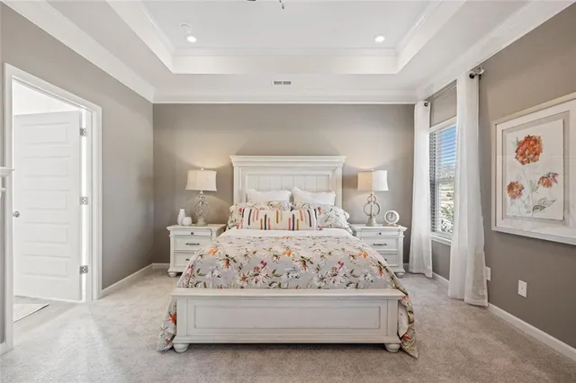 a bedroom with a bed and a painting