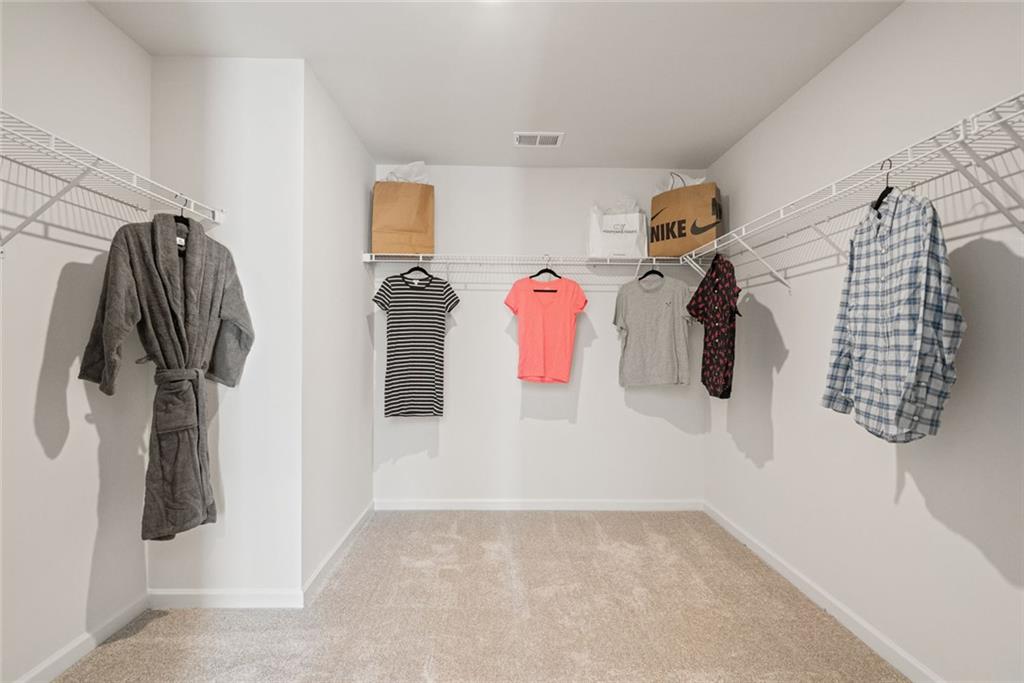 23 Willow Circle Rock Spring, GA 30739 - Photo 31 of 33 a view of walk in closet with clothes and shoes