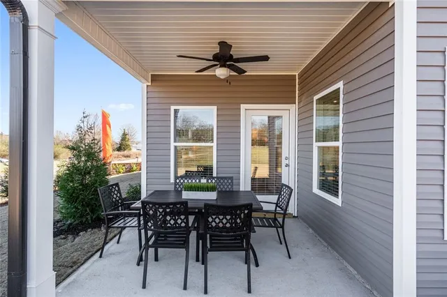 a view of an outdoor dining space with a table and chairs
