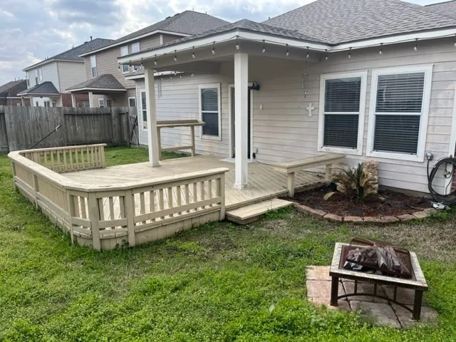 a view of a house with a yard and furniture