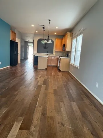 a view of a kitchen with a sink and wooden floor