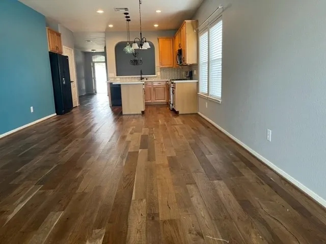 a view of kitchen with cabinets stainless steel appliances with wooden floor