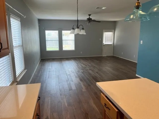 a view of kitchen and hall with wooden floor