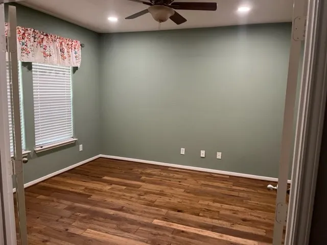 a view of a room with window and a ceiling fan