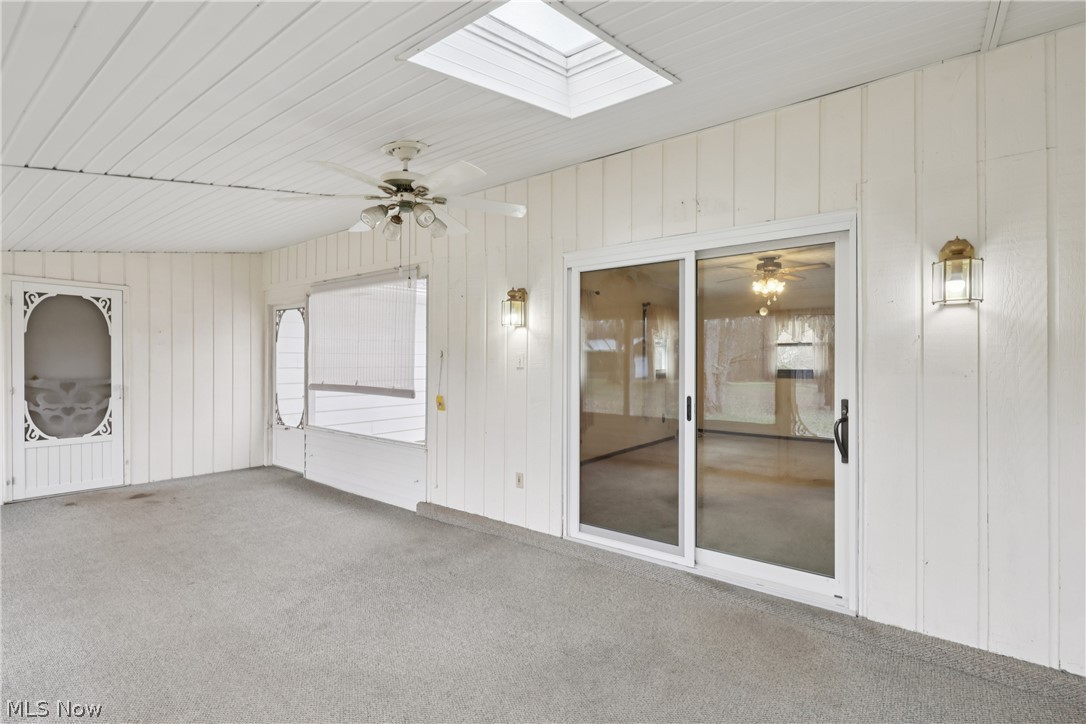 402 Yager Road Clinton, OH 44216 - Photo 29 of 38 Sun room / 3 season room with 2 ceiling fan / lights, skylight and carpet flooring