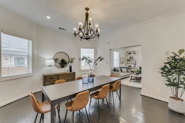 a view of a dining room with furniture wooden floor and chandelier