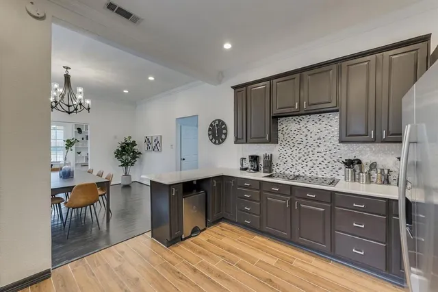 a kitchen with stainless steel appliances granite countertop a sink dishwasher and cabinets with wooden floor