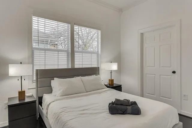 a bedroom with a bed and a lamp