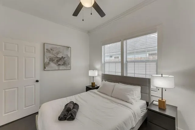 a bedroom with a bed and a lamp on dresser