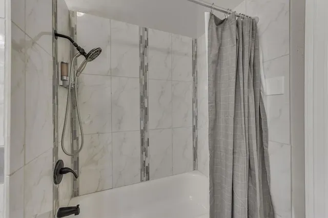 a bathroom with a shower and a glass door