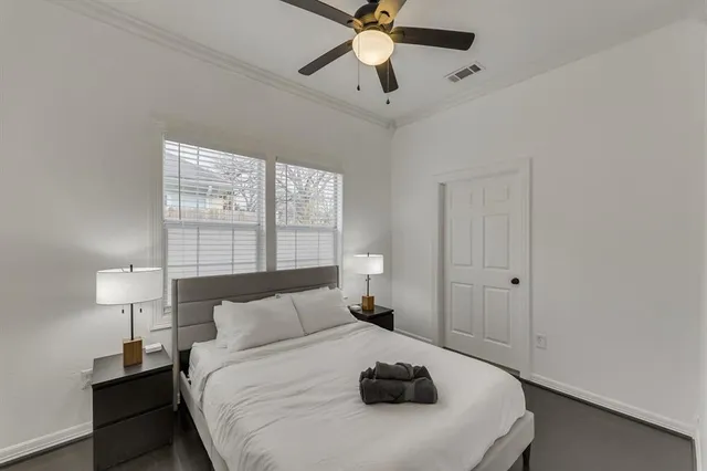 a bedroom with a bed and a lamp