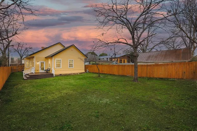 a view of a backyard with a large tree