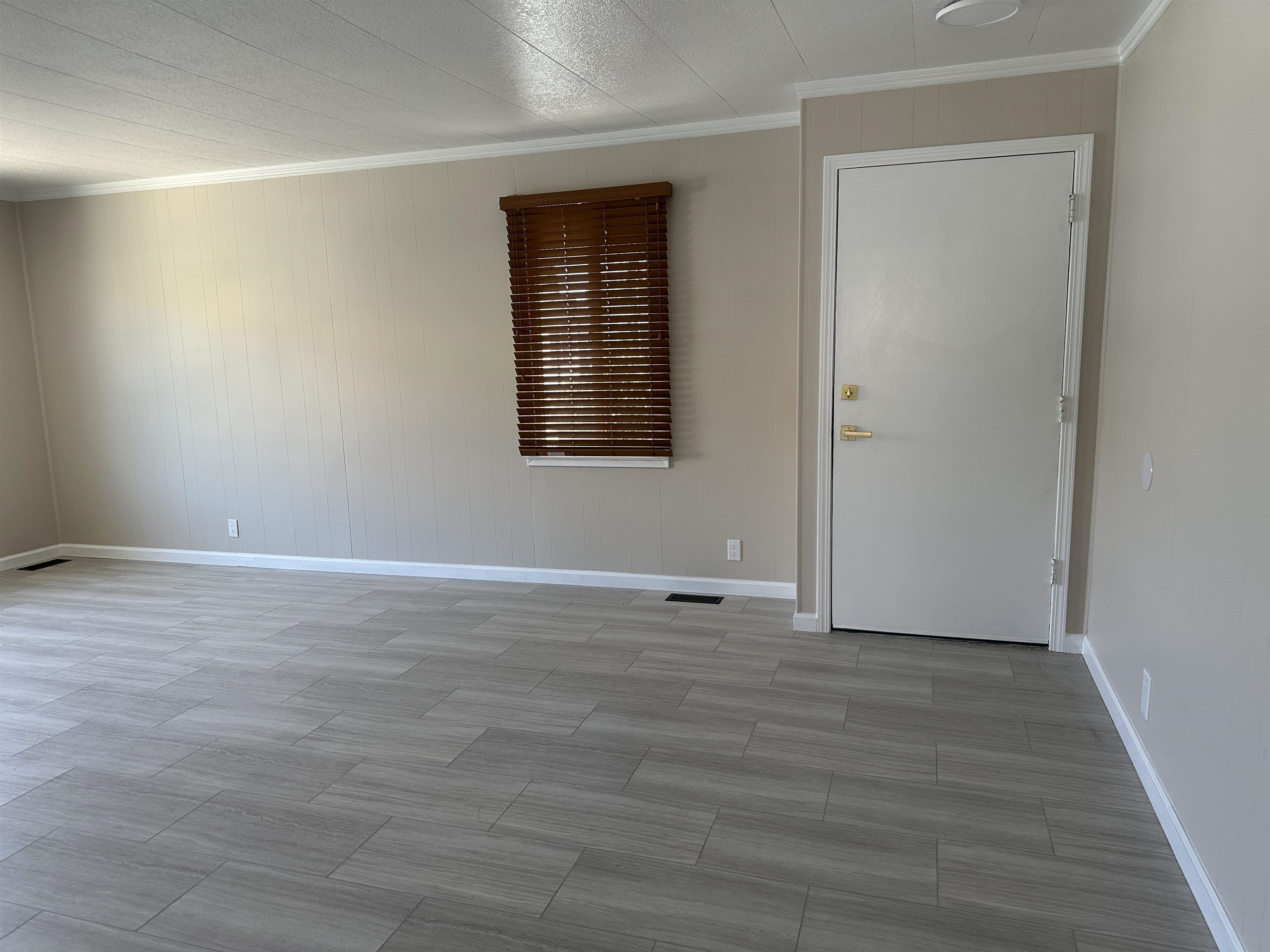 711 Old Canyon Road, Unit 56 Fremont, CA 94536 - Photo 13 of 42 a view of an empty room with wooden floor and a window