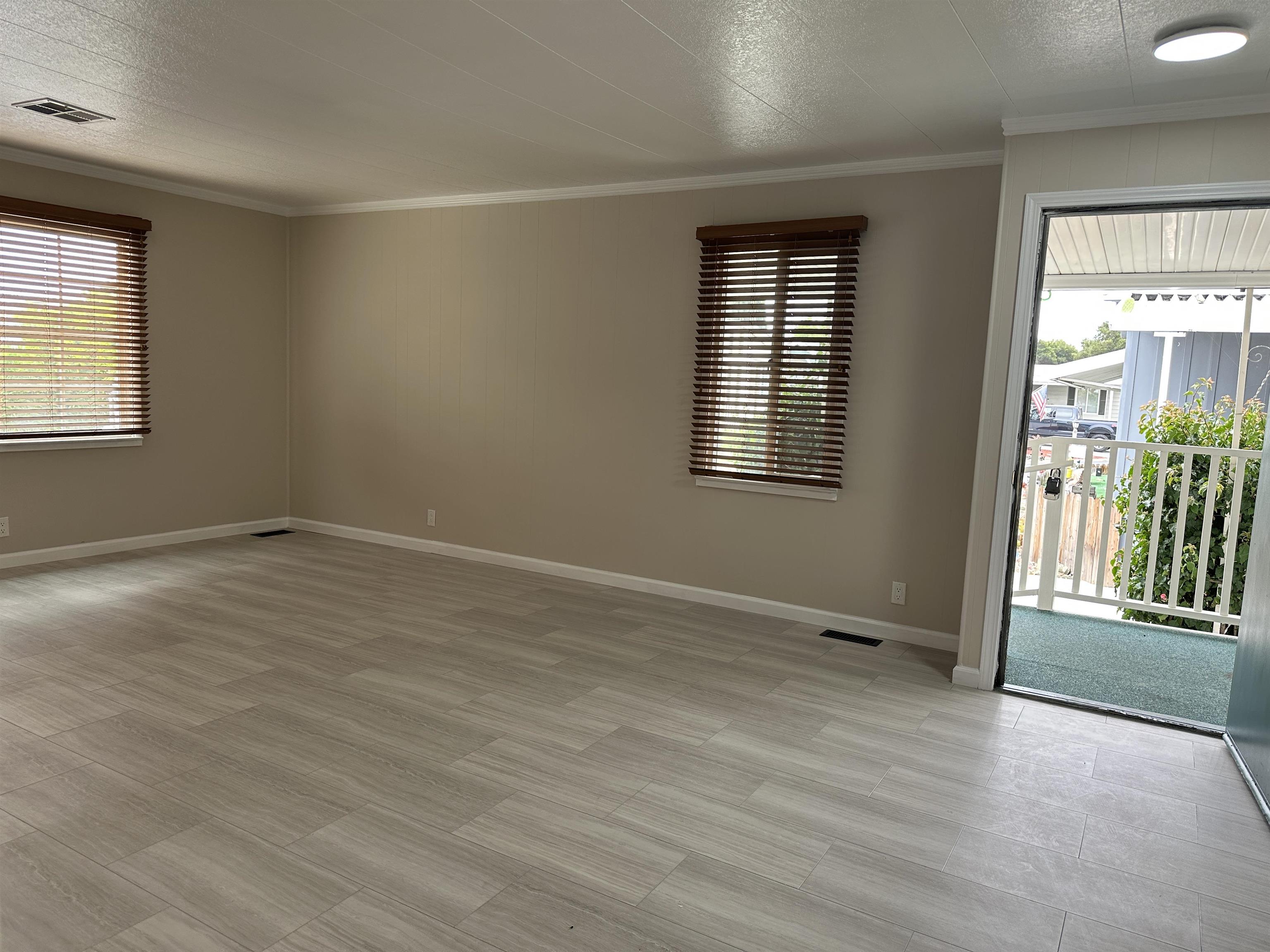 711 Old Canyon Road, Unit 56 Fremont, CA 94536 - Photo 14 of 42 an empty room with wooden floor and windows