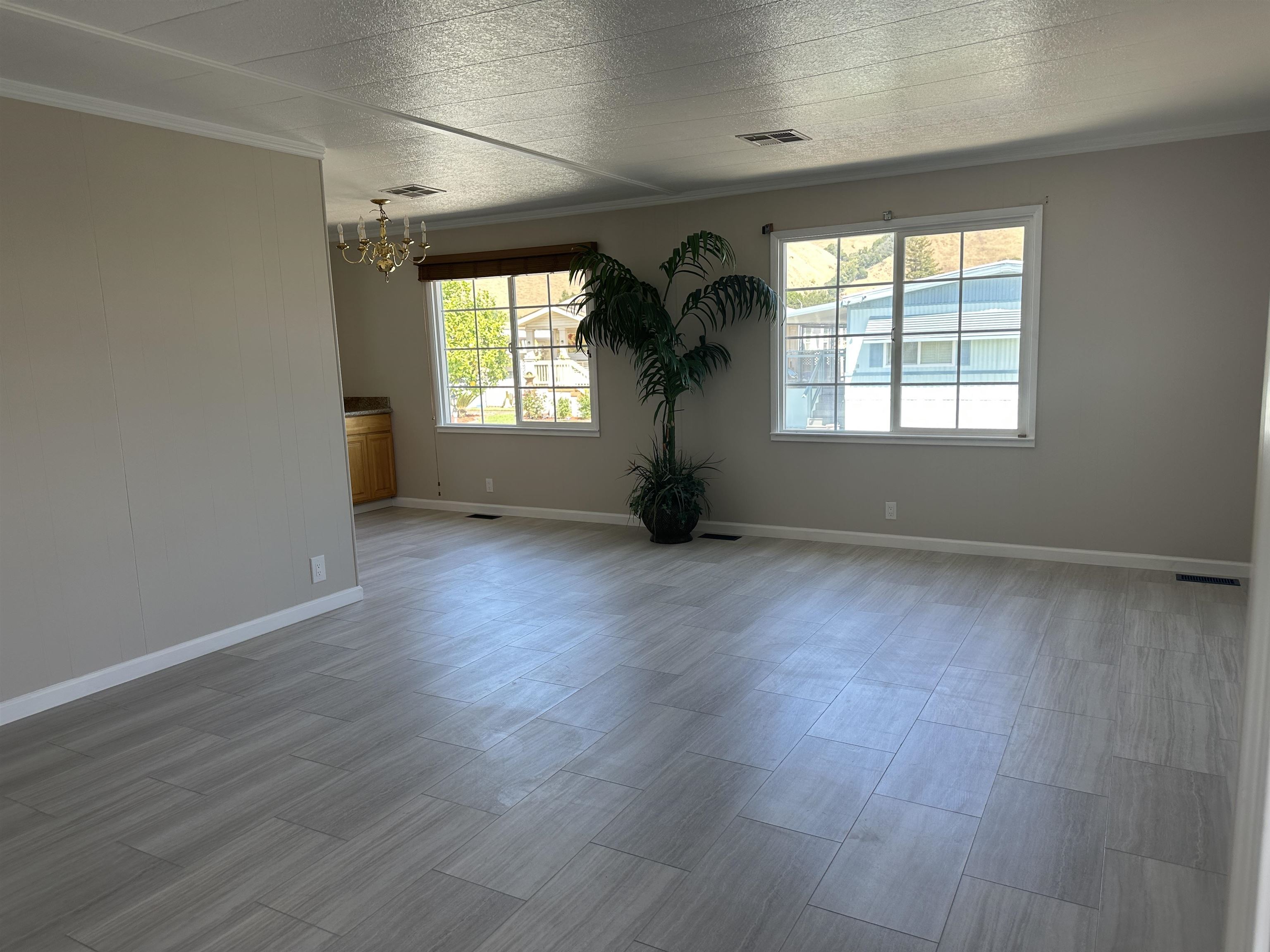 711 Old Canyon Road, Unit 56 Fremont, CA 94536 - Photo 6 of 42 an empty room with wooden floor and a window