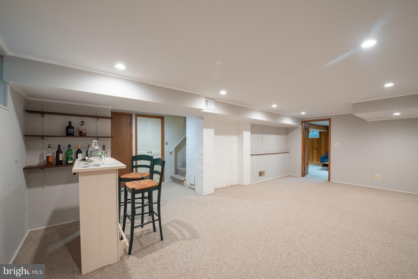 7923 New Market Road Alexandria, VA 22308 - Photo 27 of 42 Family room with retro bar & stools that convey