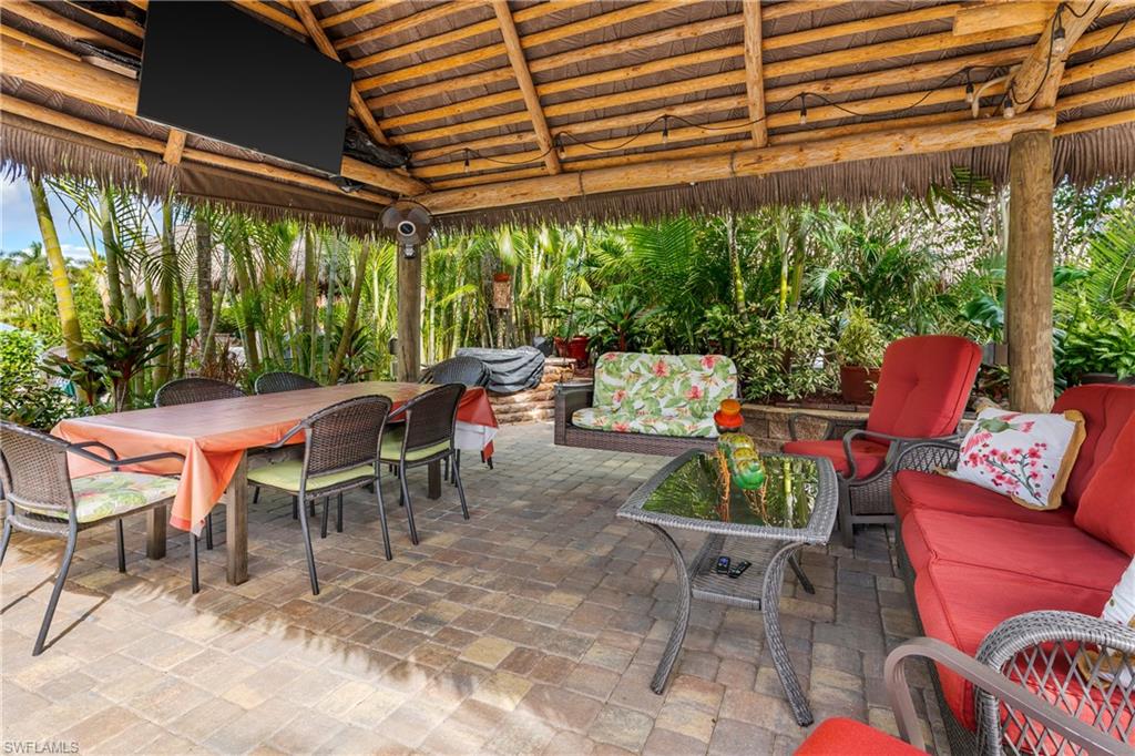 13446 Ladyfish Lane Naples, FL 34114 - Photo 11 of 44 a view of a patio with table and chairs and potted plants