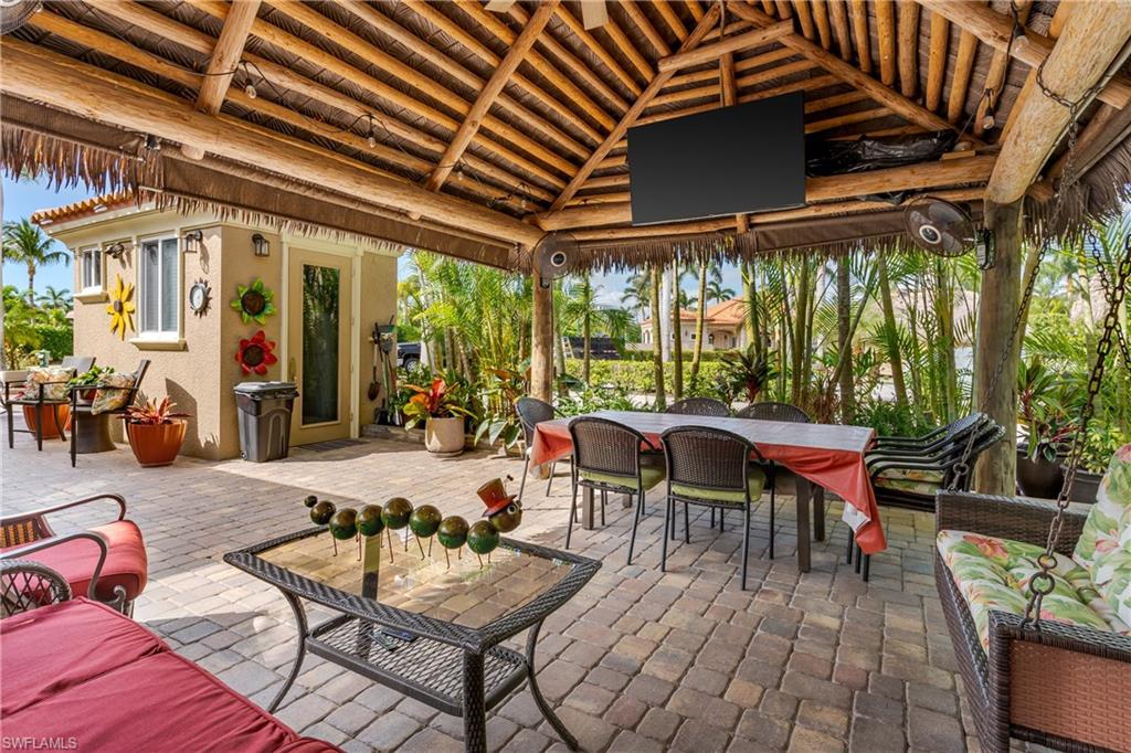 13446 Ladyfish Lane Naples, FL 34114 - Photo 12 of 44 a outdoor space with lots of furniture and a fireplace