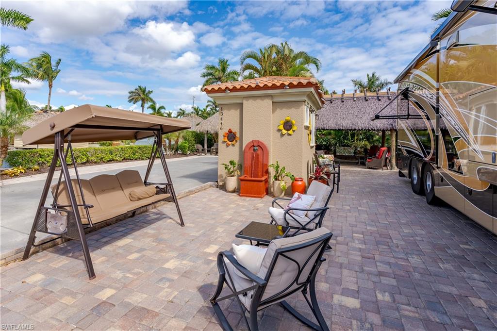 13446 Ladyfish Lane Naples, FL 34114 - Photo 15 of 44 a view of a chairs and tables in the patio