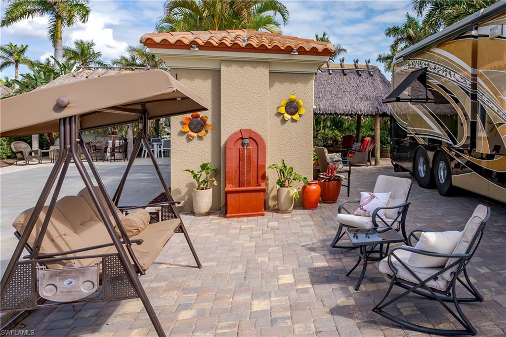 13446 Ladyfish Lane Naples, FL 34114 - Photo 16 of 44 a view of a patio with table and chairs